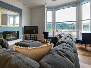 a living room with a couch and a tv at Anchorage View in Dartmouth