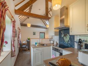 a kitchen with white cabinets and a counter top at The Granary - Uk44490 in Sedgefield