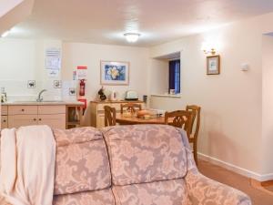 a living room with a couch and a table at Cowshed - Uk49024 in Liskeard