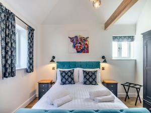 a bedroom with a bed and two windows at The Cowshed - Uk37349 in Hockerton +23 photos