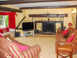 a living room with a couch and a fireplace at Silverland in Hordle +22 photos