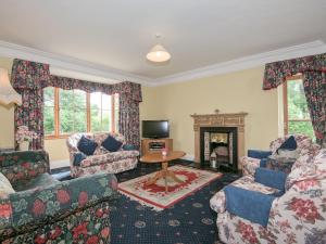 a living room with couches and a fireplace at The Vicarage in Lowick Green