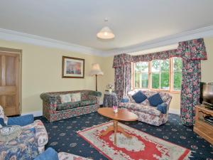 a living room with a couch and a table at The Vicarage in Lowick Green