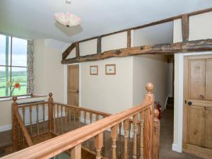 a staircase in a house with wooden beams at The Vicarage in Lowick Green +13 photos
