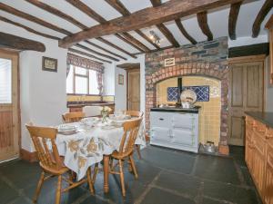 a kitchen with a table and chairs in a room at The Vicarage in Lowick Green