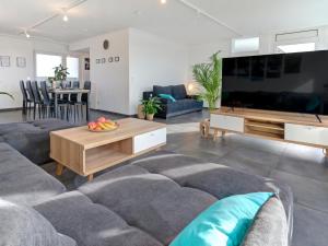 a living room with a large flat screen tv at Das Penthouse mit 3 Dachterrassen, Whirlpool & Panoramablick in Karlsruhe