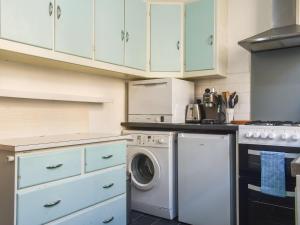 a kitchen with a washing machine and a washer at Limestone Cottage in Hebden Bridge