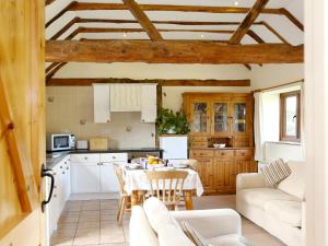 a kitchen with a table and chairs in a room at The Dairy At Copper Beeches in Petersfield