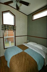 a bedroom with a large bed and a window at Arrowhead Camping Resort Cottage 11 in Douglas Center