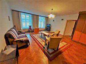 a living room with a couch and a table at Let's go back to the memories in Krakow +1 photo