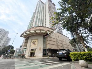 a car is parked in front of a building at Shunde Grand View Hotel in Shunde