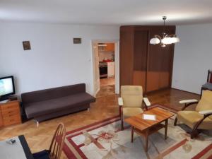 a living room with a couch and a table at Let's go back to the memories in Krakow