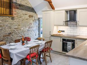 a kitchen and dining room with a table and chairs at Stables in Carmarthen