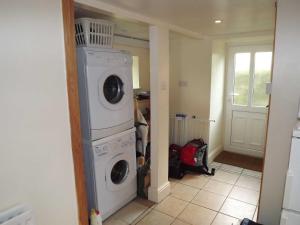 a laundry room with a washer and dryer at Skellgill House in Askrigg