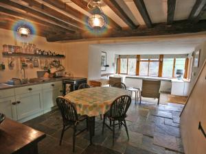 a kitchen and dining room with a table and chairs at Penroc in Pentre-briwnant