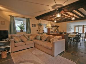 a living room with a couch and a dining room at Penroc in Pentre-briwnant
