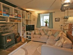 a living room with a couch and a fireplace at Penroc in Pentre-briwnant +13 photos