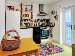 a kitchen with a table with a basket on it at Feltham's Cottage - Uk42324 in Horsington