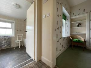 a hallway of a home with a room with a window at Birch Cottage - Uk38992 in Dalcross +10 photos