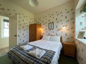 a bedroom with a bed and a wall covered in stickers at Birch Cottage - Uk38992 in Dalcross