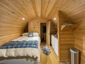 a bedroom with a bed in a wooden cabin at Now - Uk50567 in Port of Menteith