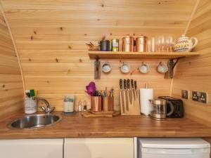 a kitchen with a sink and a counter with utensils at Now - Uk50567 in Port of Menteith
