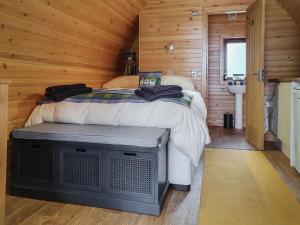 a bedroom with a bed in a wooden cabin at Now - Uk50567 in Port of Menteith