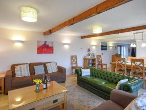 a living room with a couch and a table at Lower House Barn in Staunton on Wye