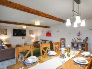 a dining room and living room with a table at Lower House Barn in Staunton on Wye