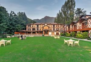 a large building with tables and chairs on a lawn at Fortune Resort Heevan, Srinagar - Member ITC Hotels' Group in Srinagar