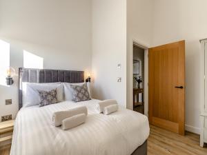 a bedroom with a large white bed with two pillows at The Piggery - Uk37348 in Hockerton +12 photos