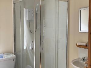a bathroom with a shower and a sink at Sanna in Ardentinny