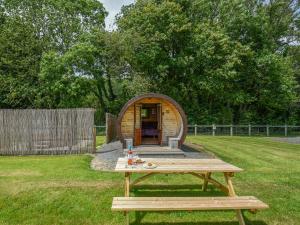 a picnic table in a yard with a circular building at Willow - Glamping Pod - Uk49947 in Oswestry