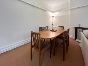 a dining room table with chairs and a lamp on it at Seawinds - Uk50857 in Colwyn Bay