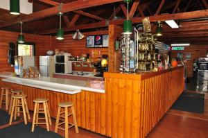 a bar in a restaurant with stools at Arrowhead Camping Resort Loft Cabin 20 in Douglas Center +10 photos