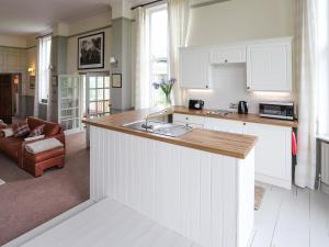 a kitchen with white cabinets and a counter top at Stargazers - Uk3445 in Greenhaugh