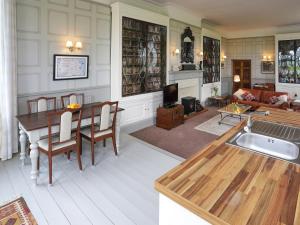 a kitchen and living room with a table and a couch at Stargazers - Uk3445 in Greenhaugh