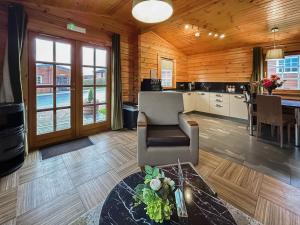 a living room with a couch and a table at Lodge 4 - Uk51264 in Glasgow +7 photos