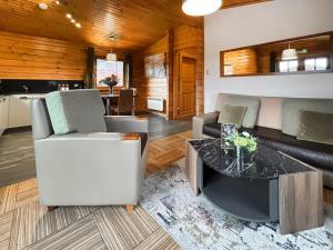 a living room with a couch and a table at Lodge 4 - Uk51264 in Glasgow