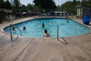 a group of people swimming in a swimming pool at Tranquil Timbers Yurt 3 in Sturgeon Bay