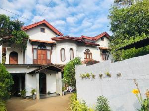 a white house with a fence in front of it at Anjana Villa in Katunayaka