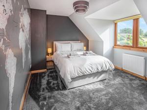 a bedroom with a large bed and a window at Beinn View House in Cononbridge +13 photos