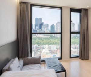 a room with a bed and a large window at Celib Yeoui in Seoul