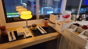 a counter with a table with food and a window at Stay PLAN B in Seoul +28 photos