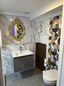 a bathroom with a sink and a toilet and a mirror at Leyenda Boutıque Hotel in Istanbul +59 photos