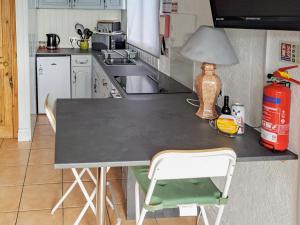 a kitchen with a table with a lamp on it at The Revie in Bridlington