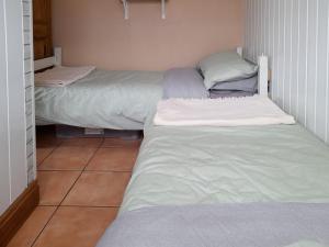 two beds in a small room withermottermottermott at The Revie in Bridlington