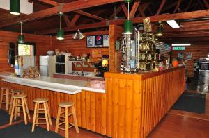 a bar in a restaurant with stools at Arrowhead Camping Resort Deluxe Cabin 14 in Douglas Center