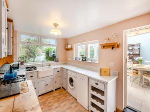a kitchen with a washer and dryer at Lillie's Cottage in Sewerby