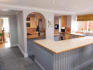 a kitchen with a counter and an archway at Croeso in Conwy